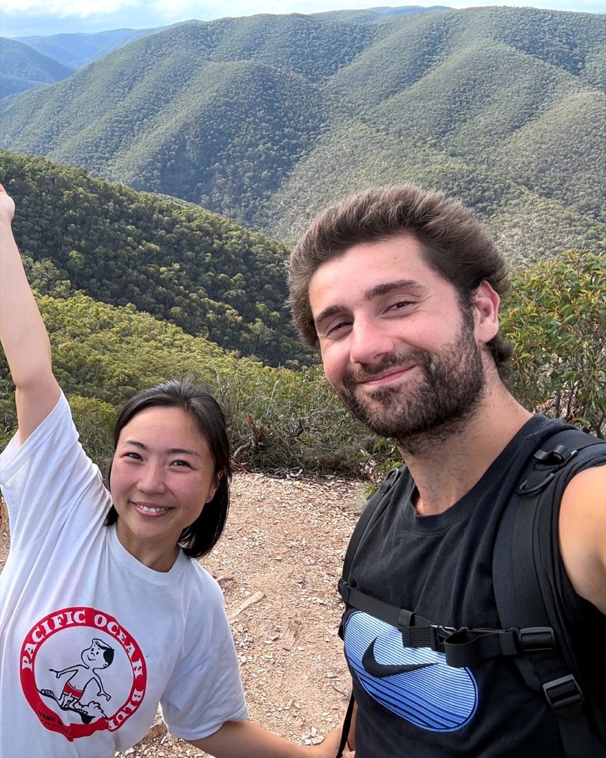 Jack and Coco, founders of J & Co Ventures, smiling together on a mountain summit